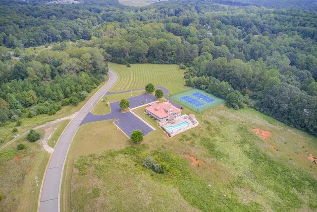 Aerial of the clubhouse with swimming pool and tennis court
